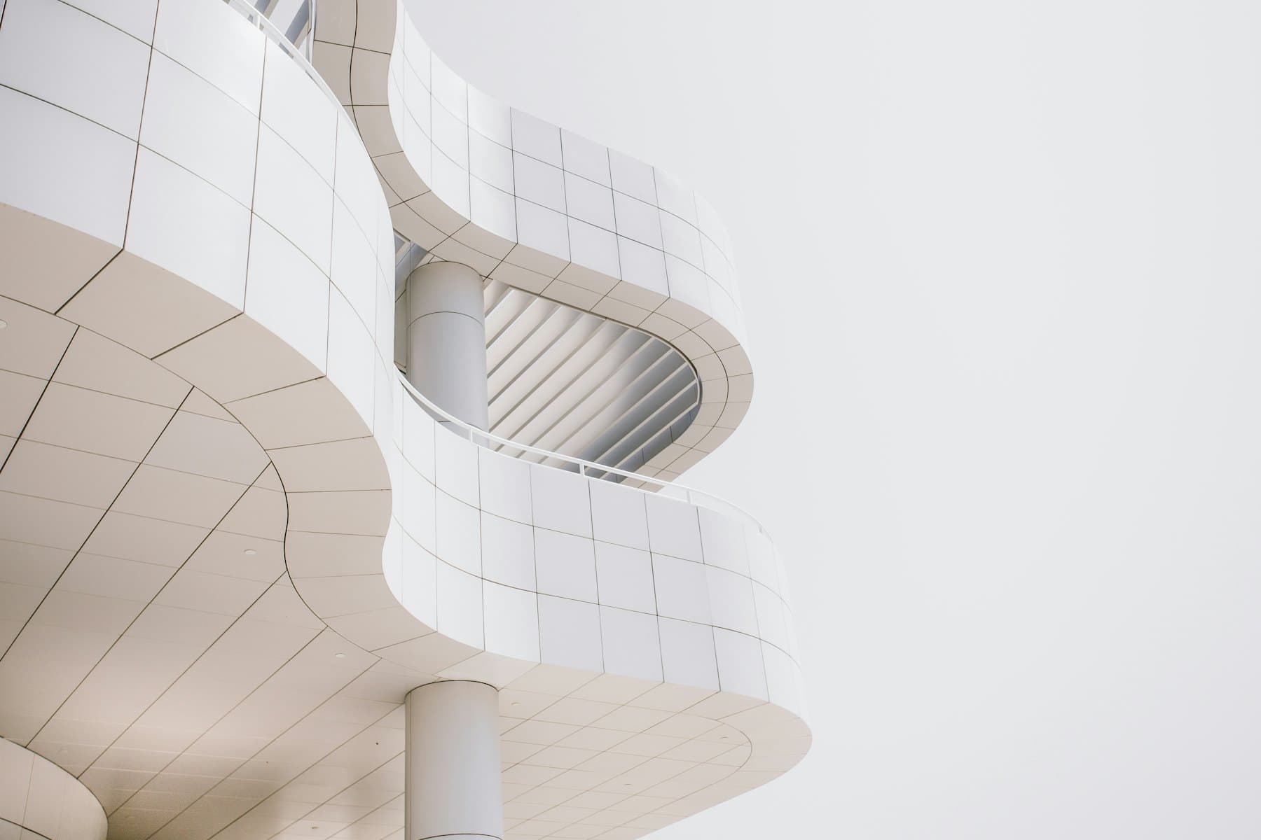 A concrete facade seen from below, its floors receding in strict repetition