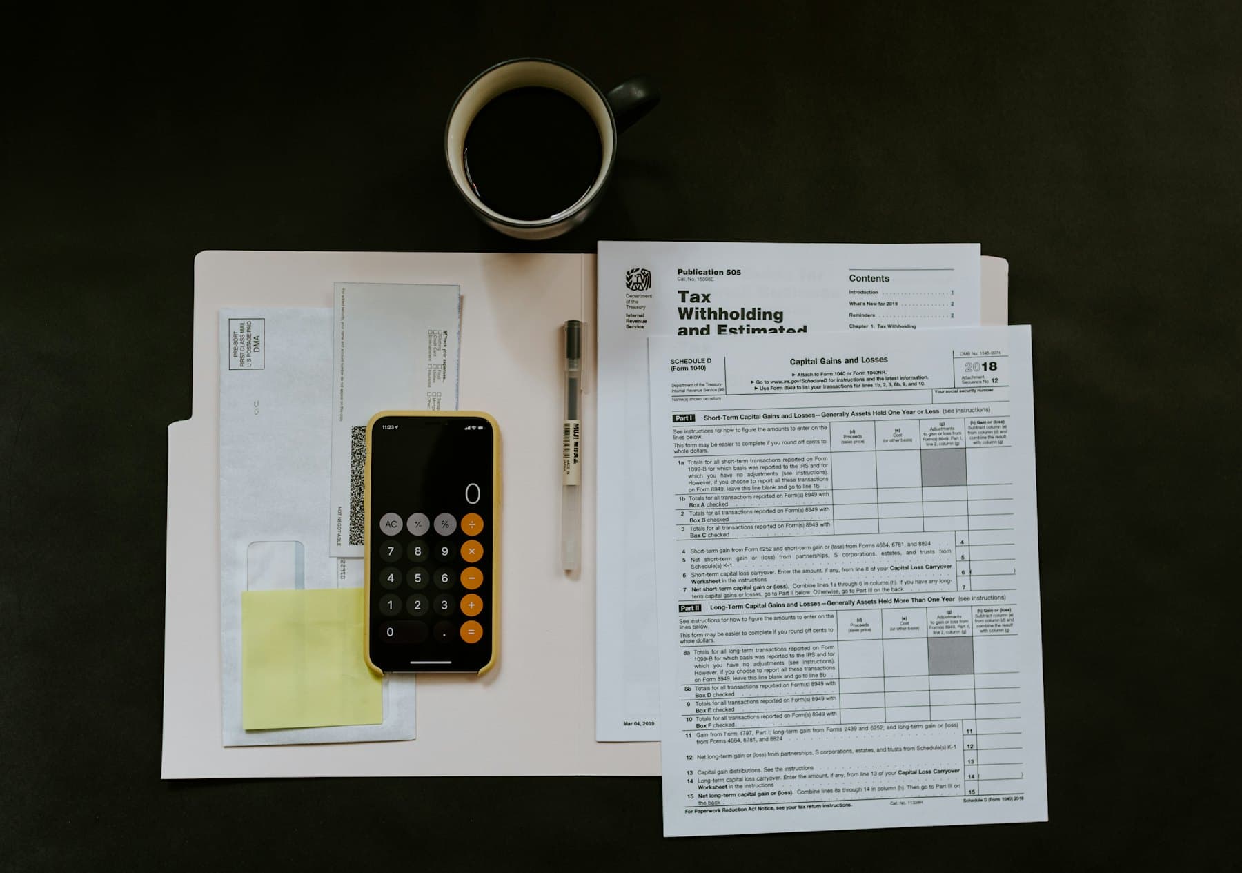 A single filed tax document lying flat on a clean white folder with a pen