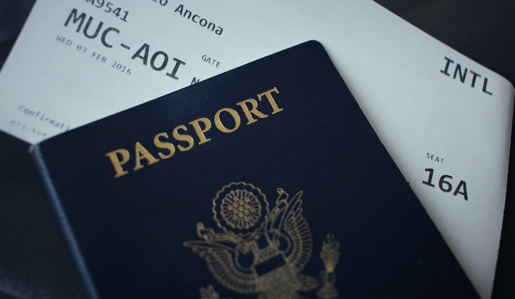 An open passport resting on a sheet of white paper